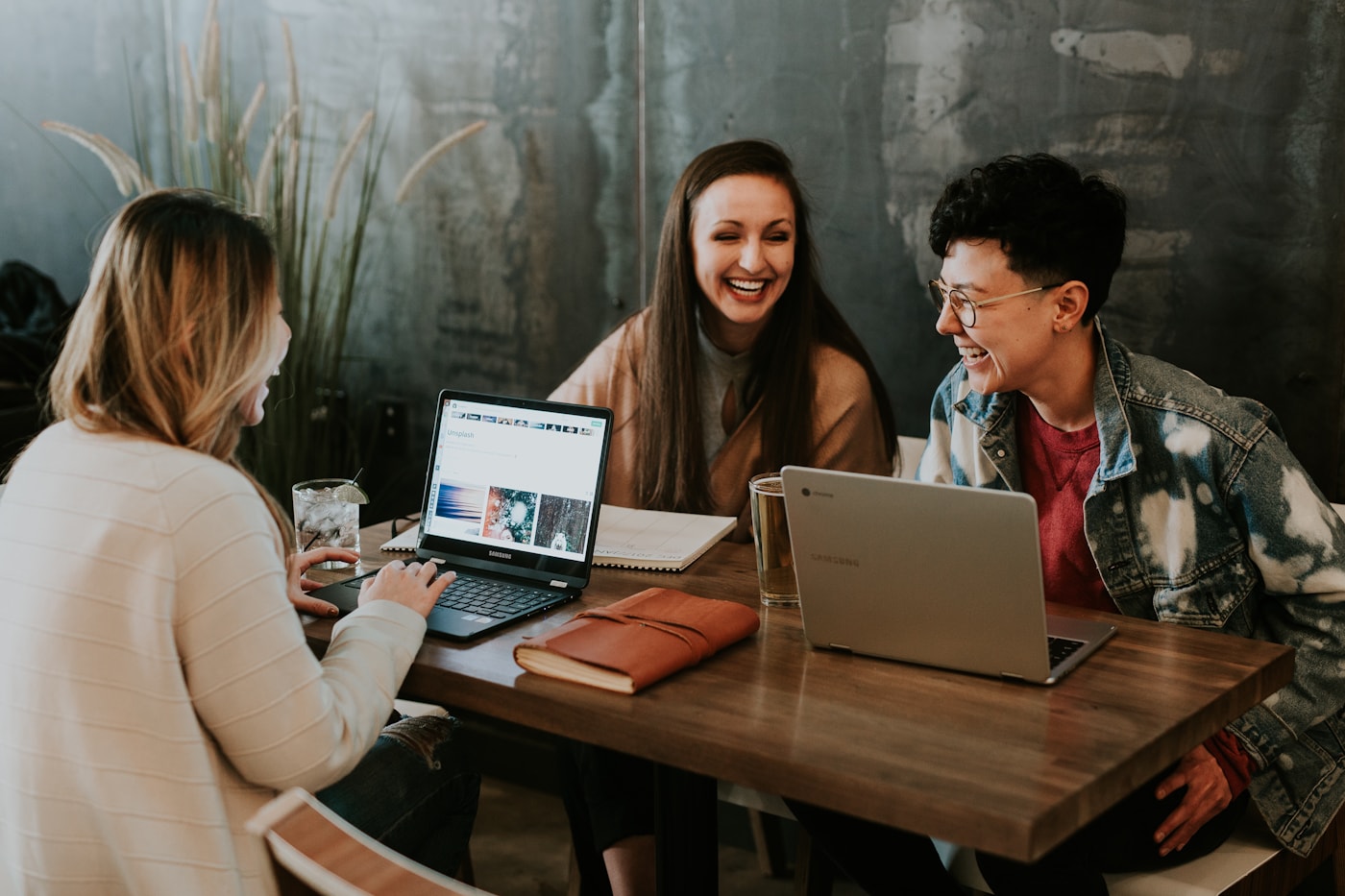 People discussing product work around a laptop