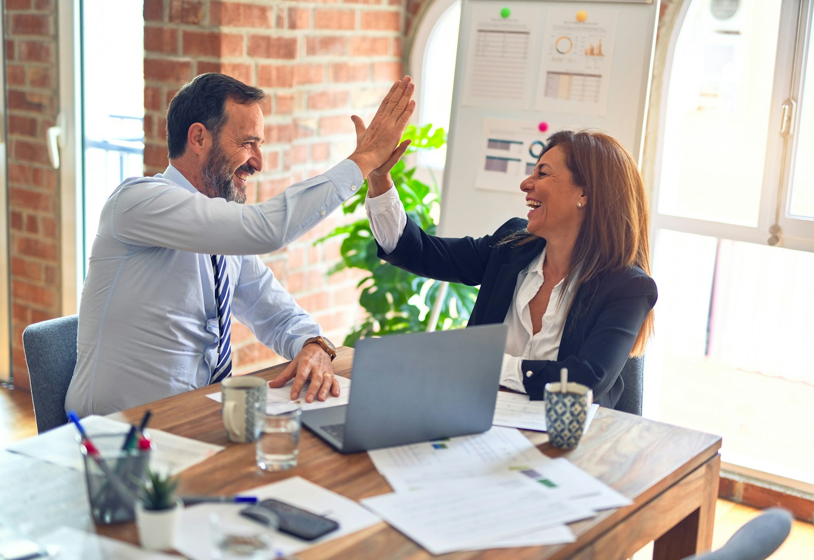 Successful client conversation around a laptop